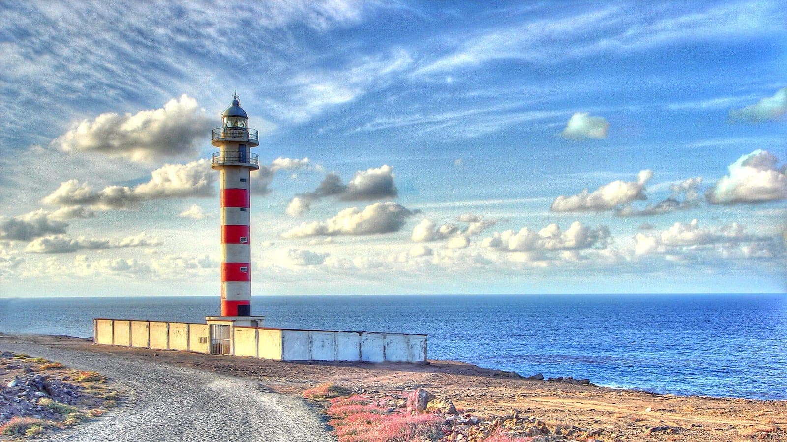 The Sardina lighthouse on the Gáldar coast at sunset, with the Atlantic Ocean behind, north of Gran Canaria